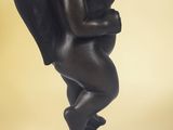 statue of a woman holding a baby on a black base