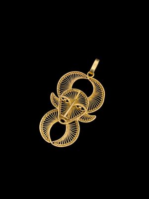 un pendentif plaqué or orné d'un motif en spirale sur fond noir