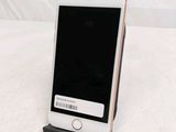 a cell phone that is on a stand on a bed