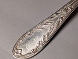 a silver spoon that is sitting on a table