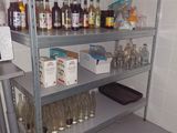 a metal shelf with bottles on it in a room
