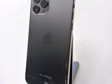 a broken iphone sitting on a stand on a table