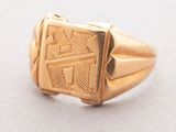 an image of a gold ring with a design on it