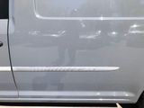 a white van parked in a parking lot with its door open