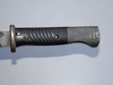 a close up of a knife on a white surface