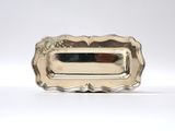 a silver plate with a handle and a handle that is attached to it