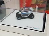 a small toy car in a display case on a table