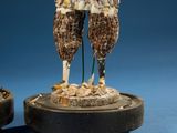 two figurines of a man and a woman standing on a pedestal