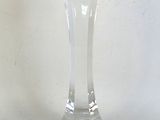 a clear glass candle holder on a white table