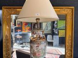 a lamp that is sitting on a table in front of a mirror