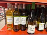 many bottles of wine on the shelf in the store