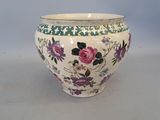 a white vase with pink and purple flowers on it