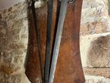 a wall mounted clock with two swords attached to it