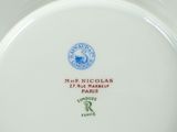 a white plate with a blue and green design on it