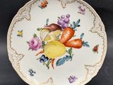 a plate with fruit and vegetables on it on a table