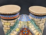 two vases that are sitting on a table