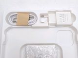 a white box with a charger and a cable
