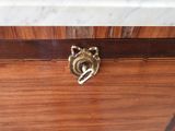 a wooden chest with a brass lock on it