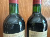 two bottles of wine that are sitting on a table