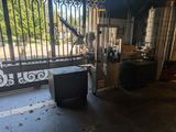 un téléviseur posé devant un portail d'un immeuble
