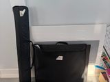 a laptop and a case sitting on the floor next to each other