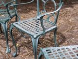 three chairs and a table on the ground in the yard