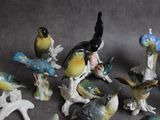 a lot of figurines of birds that are sitting on a table