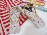 a pair of flip flops on a towel next to a pair of shoes