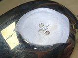 a close up of a black and white vase on a table