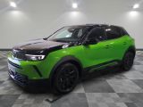 a green suv is parked in a room with a checkered floor