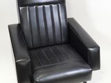 black leather chair with foot rest and foot rest on white background