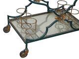 a metal cart with a glass top on wheels