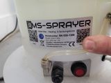 a person that is holding a sprayer in their hand