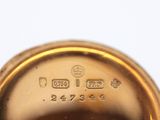 an image of a close up of a gold plated clock on a white surface