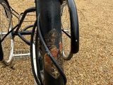 a bicycle that is chained to a pole in the driveway