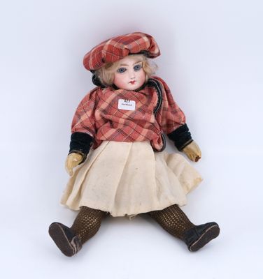 an image of a doll sitting on the ground wearing a dress and hat