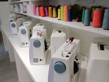 many spools of thread on the shelves in the sewing room