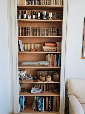 une bibliothèque remplie de livres, placée dans un coin de la pièce