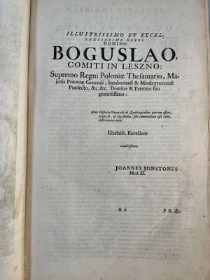 an old book with a black and white cover sitting on top of a table