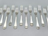 six forks and six spoons sitting on top of a table