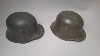 two helmets are sitting next to each other on a table