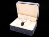 a watch that is in a box on a black background