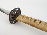 a close up of a sword with a wooden handle