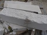 a person holding a large block of concrete on the ground