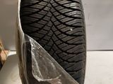 a close up of a tire on a white surface with a piece of plastic covering it