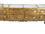 an image of a gold chest of drawers with glass top