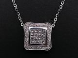 a white gold and diamond pendant on a black background