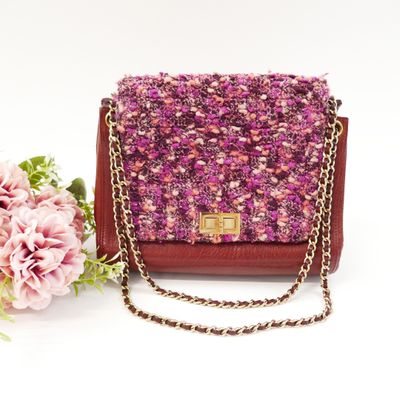 pink and brown tweed purse with chain and flowers on a white background