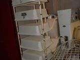 une étagère métallique située à côté des toilettes dans une pièce