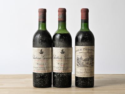 three bottles of wine sitting on top of a wooden table